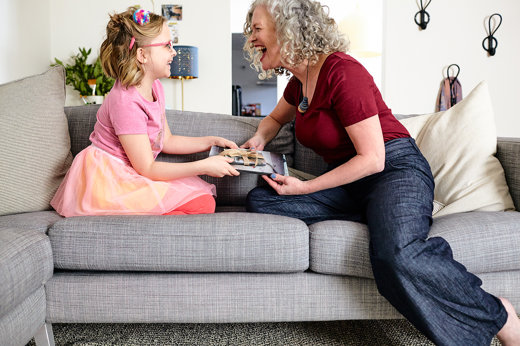 Grandma gets a gift at home. Lifestyle photography by Leah Verwey. 