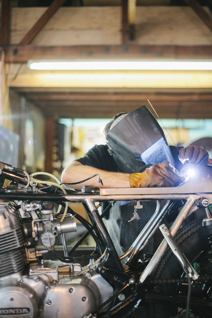 Welding a motorcycle by documentary style photographer Leah Verwey