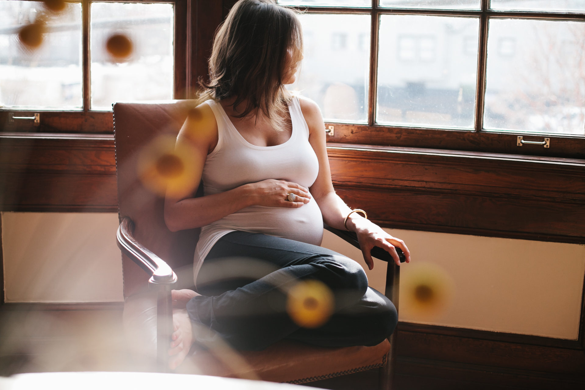 A pregnant mama reclines in a chair at home. Leah Verwey Photo