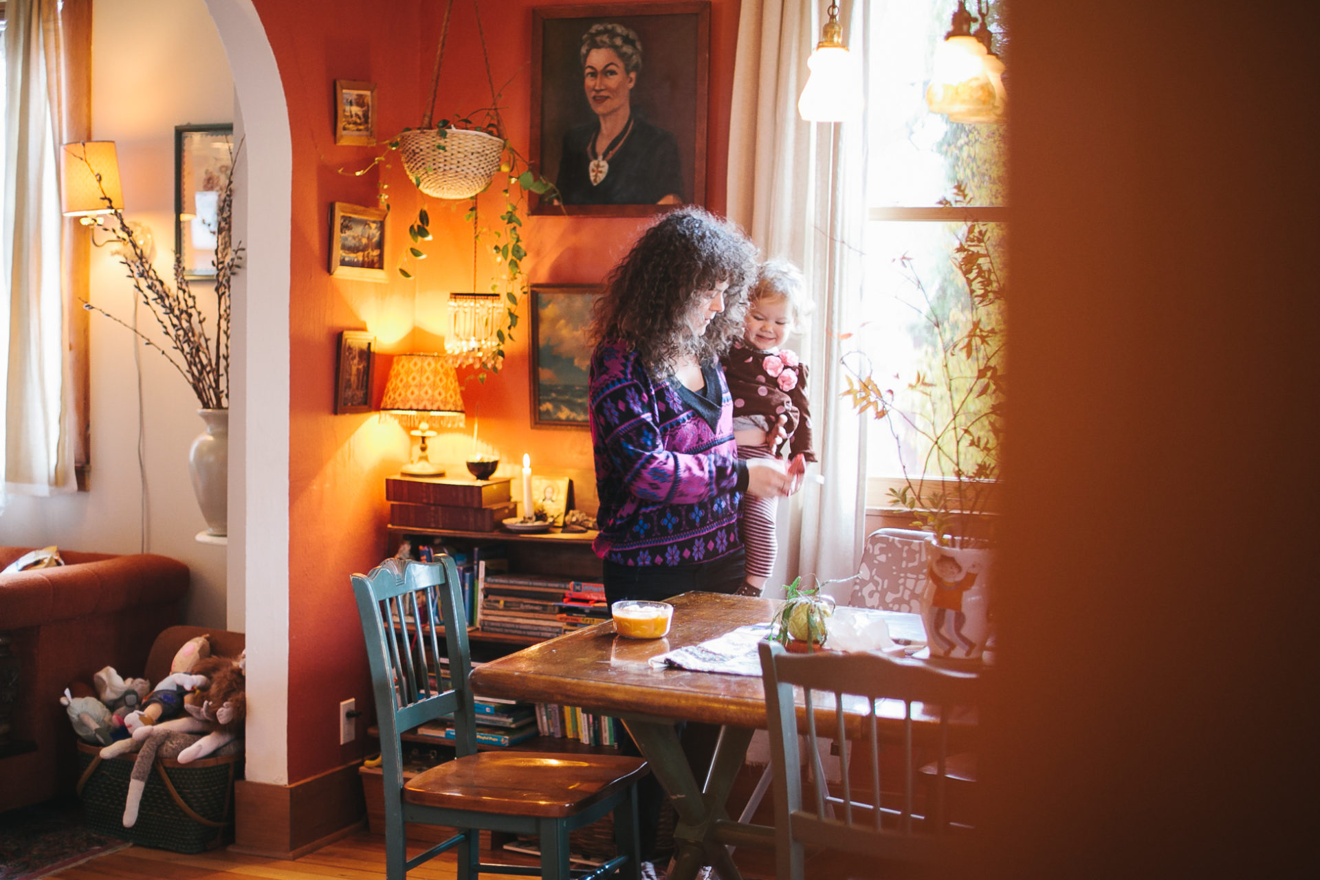 A mom preps lunch with her child in a documentary style photograph.